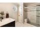 Modern bathroom with walk-in shower, tiled walls, and single vanity at 265 Crooked Creek Trl, Canton, GA 30115