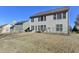 Backyard view of two-story home with patio furniture and a fenced yard at 635 Earlham Dr, Suwanee, GA 30024