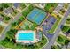 Aerial view of community amenities, including a pool, tennis courts, and basketball court at 635 Earlham Dr, Suwanee, GA 30024