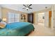 Spacious bedroom with teal bedding, ceiling fan, and en-suite bathroom access at 1532 Oak Grove Rd, Decatur, GA 30033