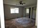 Spacious main bedroom with mirrored closet doors, ceiling fan, and subfloor at 3817 Raiders Ridge Dr, Lithonia, GA 30038