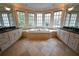 Large bathroom with corner jetted tub, dual vanities, and large windows at 1378 Wesley Oaks Nw Ct, Atlanta, GA 30327