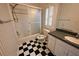 Bathroom with black and white checkered floor, shower, toilet, and vanity at 1378 Wesley Oaks Nw Ct, Atlanta, GA 30327