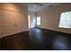Empty bedroom with dark flooring, ceiling fan, closet, and windows at 1378 Wesley Oaks Nw Ct, Atlanta, GA 30327
