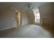 Empty bedroom with carpet, ceiling fan, built-in shelves, and window at 1378 Wesley Oaks Nw Ct, Atlanta, GA 30327