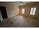 Empty bedroom with carpet, ceiling fan, and two large windows with shutters at 1378 Wesley Oaks Nw Ct, Atlanta, GA 30327