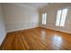 Dining room with shiny hardwood floors, white chair rail, and large windows at 1378 Wesley Oaks Nw Ct, Atlanta, GA 30327