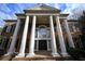 Close-up of stately brick home's entrance with columns and arched window at 1378 Wesley Oaks Nw Ct, Atlanta, GA 30327