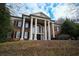 Stately brick home with grand columns and a manicured lawn at 1378 Wesley Oaks Nw Ct, Atlanta, GA 30327