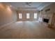 Large living room with fireplace, built-in shelves, and carpet at 1378 Wesley Oaks Nw Ct, Atlanta, GA 30327