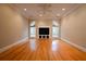 Living room featuring hardwood floors, arched windows, and built-in entertainment center at 1378 Wesley Oaks Nw Ct, Atlanta, GA 30327