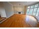 Living room with hardwood floors, fireplace, and large windows at 1378 Wesley Oaks Nw Ct, Atlanta, GA 30327