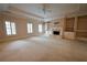 Spacious living room with fireplace, built-in shelves, and carpet at 1378 Wesley Oaks Nw Ct, Atlanta, GA 30327