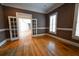 Home office with hardwood floors, french doors, and brown walls with white trim at 1378 Wesley Oaks Nw Ct, Atlanta, GA 30327
