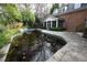 Empty inground pool with surrounding patio and screened porch at 1378 Wesley Oaks Nw Ct, Atlanta, GA 30327