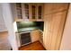Convenient wet bar with granite countertops, a wine cooler, and glass-front cabinets at 1378 Wesley Oaks Nw Ct, Atlanta, GA 30327