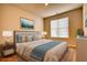 Virtually staged bedroom with a comfortable bed, nightstands, and a window with blinds at 711 Park Place Way, Social Circle, GA 30025