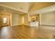 Open living area with kitchen access, wood-look floors, and entryway at 711 Park Place Way, Social Circle, GA 30025