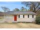 Ranch style home with red front door, black shutters, and well-maintained lawn at 2625 Abner Nw, Atlanta, GA 30318