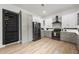 Modern kitchen boasts a wine rack, black appliances, and light wood floors at 2167 Montrose Ave, Atlanta, GA 30311