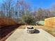 Fenced backyard with a fire pit and surrounding patio at 3723 Verde Glen Ln, Cumming, GA 30040