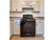 Kitchen with black appliances, gray cabinets, and wood-look flooring at 3723 Verde Glen Ln, Cumming, GA 30040