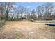 Spacious backyard with a wooden deck, trees, and fencing at 6709 Londonderry Dr, Morrow, GA 30260