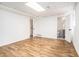 Open basement area with wood floors, white walls, a bathroom, and stairs at 6709 Londonderry Dr, Morrow, GA 30260