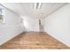 Finished basement with wood-look flooring, white walls, drop ceiling, and stairs at 6709 Londonderry Dr, Morrow, GA 30260