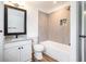 Modern bathroom with tiled shower, white vanity, and wood-look flooring at 6709 Londonderry Dr, Morrow, GA 30260