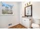 Bathroom featuring white vanity, granite countertop, and wood-look flooring at 6709 Londonderry Dr, Morrow, GA 30260
