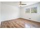 Spacious bedroom with wood floors, white walls, and large windows offering ample natural light at 6709 Londonderry Dr, Morrow, GA 30260