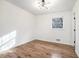 Bright bedroom with large window, wood-look floors, and white walls at 6709 Londonderry Dr, Morrow, GA 30260