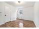 Sunlit bedroom with hardwood floors, white walls, and a large window at 6709 Londonderry Dr, Morrow, GA 30260
