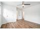 Bright bedroom with wood-look flooring, ceiling fan, and white walls at 6709 Londonderry Dr, Morrow, GA 30260