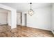 Dining room with modern light fixture, wood-look flooring, and white shiplap walls at 6709 Londonderry Dr, Morrow, GA 30260