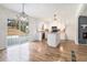 Updated kitchen with white cabinets, granite countertops, an island, and modern light fixtures at 6709 Londonderry Dr, Morrow, GA 30260