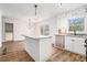 Modern kitchen featuring white cabinets, a granite island, stainless steel appliances, and sliding glass doors at 6709 Londonderry Dr, Morrow, GA 30260