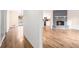 View of living room with fireplace, wood floors, and entryway to dining and kitchen at 6709 Londonderry Dr, Morrow, GA 30260