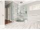 Large bathroom with a glass shower and marble-look tile at 1472 Lachona Ct, Atlanta, GA 30329