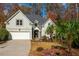 Two-story house with stone accents, landscaping, and a two-car garage at 1472 Lachona Ct, Atlanta, GA 30329