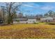 Large backyard with grassy area and mature trees at 2761 Whisper Ct, Douglasville, GA 30135