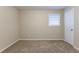 Bedroom with neutral walls, carpet flooring, and a window at 2761 Whisper Ct, Douglasville, GA 30135