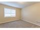 Bright bedroom featuring neutral walls and carpeted floors at 2761 Whisper Ct, Douglasville, GA 30135
