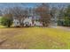 Ranch style home with red door and landscaped lawn at 2761 Whisper Ct, Douglasville, GA 30135