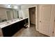 Double vanity bathroom with dark wood cabinets and tiled floor at 1323 Rosemary Ln, Atlanta, GA 30344