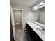 Bathroom with vanity, mirror, and toilet in separate room at 1323 Rosemary Ln, Atlanta, GA 30344