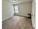 Unfurnished bedroom with carpet, window, and closet doors at 1323 Rosemary Ln, Atlanta, GA 30344