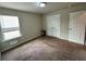 Empty bedroom with carpeted flooring, closet, and window at 1323 Rosemary Ln, Atlanta, GA 30344