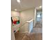Hallway with carpeted flooring, staircase, and view into a bedroom at 1323 Rosemary Ln, Atlanta, GA 30344